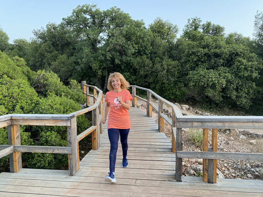 Woman walking outdoors on a wooden boardwalk