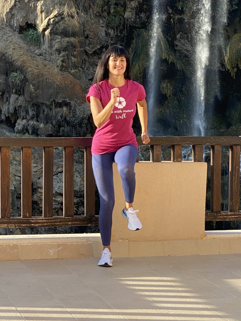 Woman doing outdoor fitness near a waterfall in Jordan