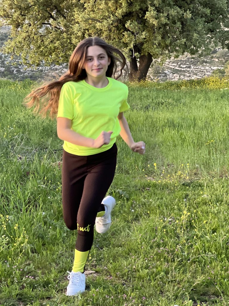 Child running outdoors on grass