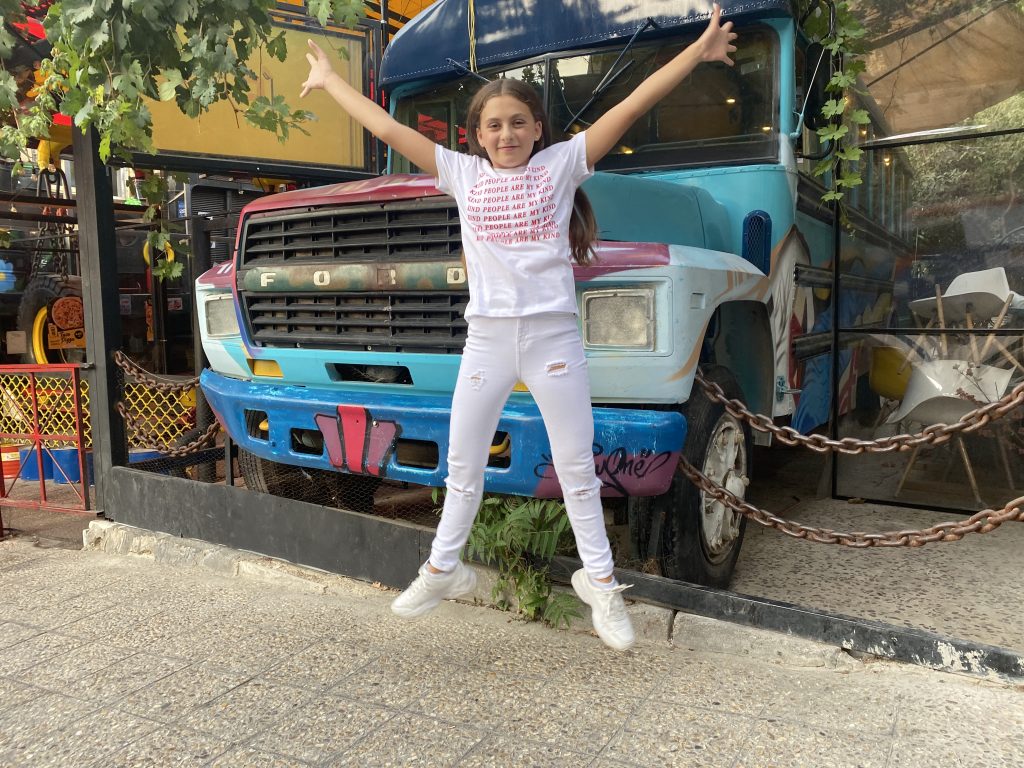 Child jumping during an outdoor RAXA Fitness Kids™ session